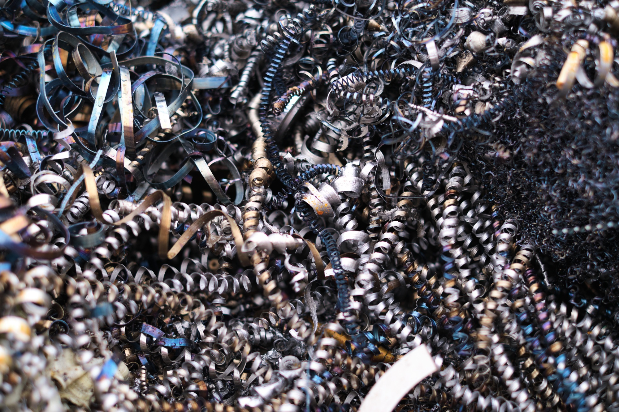 A monochromatic sea of industrial debris, illustrating the inevitable waste generated from metal